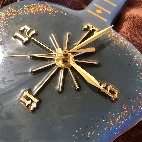 Elvis clock blue with glitter under coating. Works.